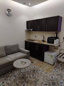 a living room with a couch and a table at شقق المحمدية - Al Mohammadia apartment in Jeddah +16 photos