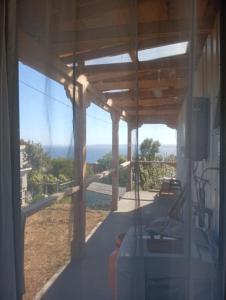 a room with a view of the ocean from a house at Cabaña con vista al mar in Tomé