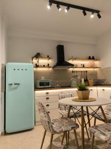a kitchen with a table and a refrigerator at Simple Home in Kardítsa