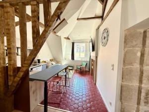 a kitchen and dining room with a table and chairs at Perfect pied-à-terre in Dijon in Dijon +11 photos