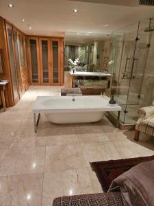 a large bathroom with a tub and a shower at The Pearls of Umhlanga, or Oceans Apts in Durban
