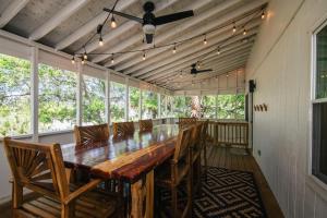 a dining room with a long table and chairs at Edisto Echo in Edisto Beach