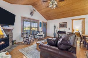 a living room with a couch and a fireplace at Grey Moose Lodge with Amenities Access in Branson West