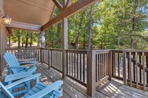 a porch with two blue rocking chairs on it at Grey Moose Lodge with Amenities Access in Branson West
