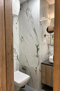 a bathroom with a toilet and a sink at Elite Stay near Expo Mart Delta 1 metro in Greater Noida