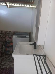 a small bathroom with a sink and a toilet at Manatea in Bora Bora