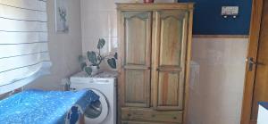 a bathroom with a washing machine and a wooden cabinet at Christmas lights accommodation Vigo in Redondela