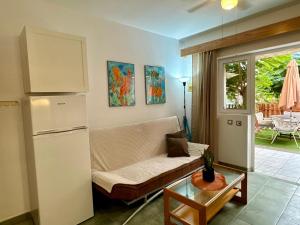 a living room with a couch and a refrigerator at Oasis Lemon in Maspalomas