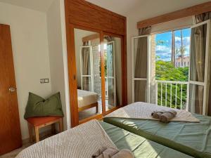 a bedroom with a bed and a view of a balcony at Oasis Lemon in Maspalomas +34 photos