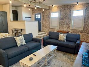 a living room with two couches and a table at Historic 706 in Mountain Home