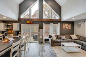 a living room with a couch and a table at White Mtns Holiday Home! Cabin 1 Mi to Skiing in Campton Upper Village