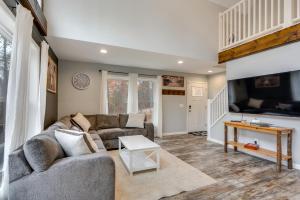 a living room with a couch and a table at White Mtns Holiday Home! Cabin 1 Mi to Skiing in Campton Upper Village