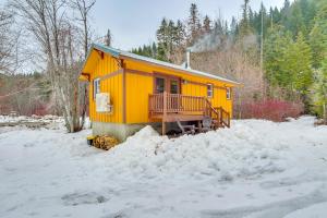 a yellow house with a balcony in the snow at Deck and Fire Pit Yakima River Retreat in Cle Elum in Cle Elum