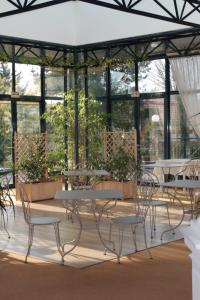 a patio with tables and chairs in a building at Résidence de Tourisme Vacances Bleues Villa Regina in Arcachon