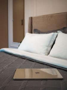 a laptop computer sitting on top of a bed at Seven Elite Apartments by Mega Mall in Almaty