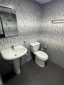 a bathroom with a toilet and a sink at Trikon Villaa in Trincomalee +18 photos