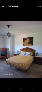 a bedroom with a large bed and a chair at La Casa del Cribero in Mieza