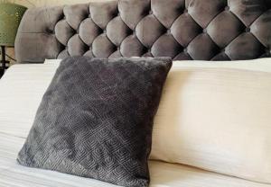 a pillow sitting on top of a bed at Fairways guest house in Preston