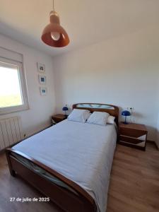 a bedroom with a large bed and a window at La Casa del Cribero in Mieza
