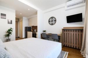 a bedroom with a bed and a clock on the wall at inJoy in Belgrade