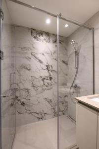 a bathroom with a shower with a glass door at inJoy in Belgrade