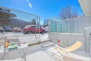 a table and a chair in the snow at Bardonest - Happy Rentals in Bardonecchia +12 photos