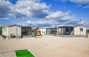 a row of houses in a parking lot at Gorgeous Stacaravan In Drnis With Wifi in Brištane