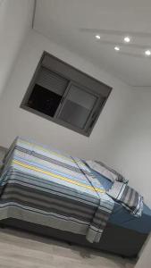 Postel nebo postele na pokoji v ubytování Apto ao lado do metrô de SP + 9 fotografií