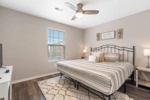 a bedroom with a bed and a ceiling fan at Rockwall Duo - Cottage & Lodge Combo in Branson