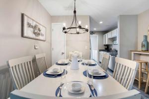 a dining room and kitchen with a white table and chairs at Rockwall Duo - Cottage & Lodge Combo in Branson