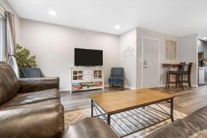 a living room with a couch and a table at Rockwall Duo - Cottage & Lodge Combo in Branson
