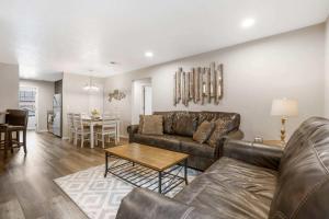 a living room with a couch and a table at Rockwall Duo - Cottage & Lodge Combo in Branson +35 photos