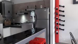 a kitchen with a stainless steel refrigerator at DEPARTAMENTOS BOUTIQUE DE DISEÑADOR " TERRAZA 26" - Cochera- Vista a la Montaña- CANCELACIÓN GRATUITA- PAGARÁS EN EL ALOJAMIENTO in Mendoza