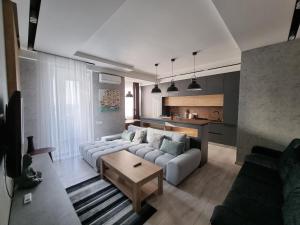 a living room with a couch and a table at Diplomat Lev Tolstoi 74 street Apartments in Chişinău