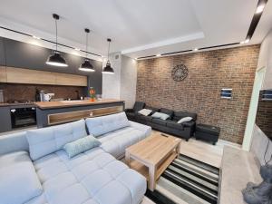 a living room with a couch and a table at Diplomat Lev Tolstoi 74 street Apartments in Chişinău