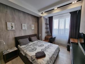 a small bedroom with a bed and a television at Diplomat Lev Tolstoi 74 street Apartments in Chişinău +30 photos