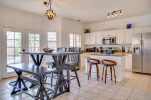 une cuisine avec une table, des chaises et un réfrigérateur dans l'établissement Close to Hospitals Goodyear Family Home with Pool!, à Perryville