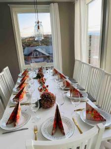 a table with plates of food and wine glasses at House by the fjord - Ocean view and jacuzzi in Forland