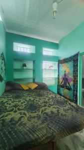 a bedroom with a large bed with blue walls at Anand hostel in Pushkar