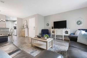 a living room with a couch and a tv at Rockwall Lodge - Close to Branson Strip in Branson
