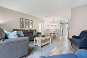 a living room with a couch and a table at Rockwall Lodge - Close to Branson Strip in Branson +16 photos