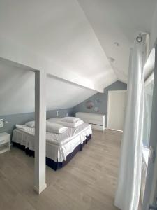 a bedroom with a bed and a white ceiling at House by the fjord - Ocean view and jacuzzi in Forland +59 photos