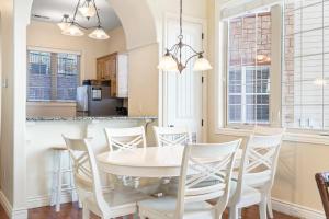 a kitchen and dining room with a white table and chairs at Sunset Retreat - 3 Min from Silver Dollar in Branson