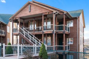 a large house with balconies and a fence at Sunset Retreat - 3 Min from Silver Dollar in Branson