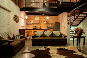 a living room with a couch and a kitchen at The Brown House in Oaxaca City