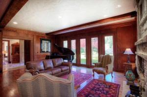 a living room with a couch and a piano at Luxurious Mountain Retreat with Pool Midway in Mound City