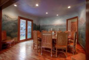a dining room with a table and a painting on the wall at Luxurious Mountain Retreat with Pool Midway in Mound City