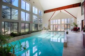 a large swimming pool with blue water in a large building at Luxurious Mountain Retreat with Pool Midway in Mound City +54 photos