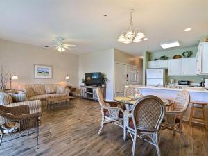 a kitchen and living room with a table and chairs at South Beach Retreat in Tybee Island