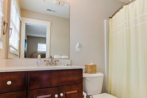 a bathroom with a sink and a toilet and a mirror at 412A The Inlet House in Virginia Beach +31 photos